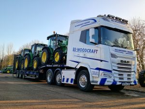 A trio of John Deere tractors heading out!